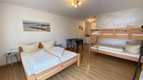 a room with two bunk beds and a table at Marianna Apartments Weimer in Rust