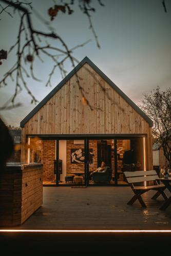 a barn with a person sitting on a couch at Nowoczesny drewniany domek CHILL HOUSE in Długosiodło