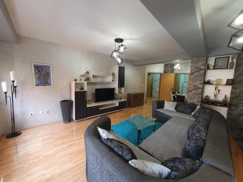 a living room with a couch and a tv at Apartman Nikolaj - Lovely 3 room apartment in the center of Ohrid in Ohrid