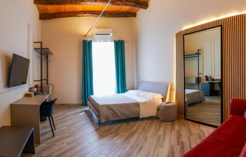a bedroom with a bed and a mirror at Rooftop Parthenopeo Contemporary Rooms in Naples
