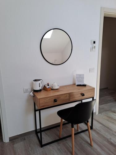 a dressing table with a mirror on a wall at Andirivieni Bellagio Guest House in Bellagio