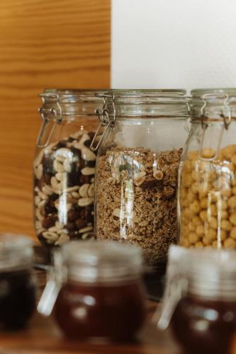 a group of jars filled with nuts and seeds at Maison du Parc - Vue canal in Hossegor
