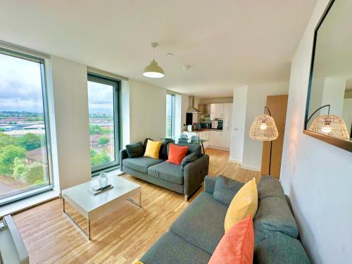 a living room with a couch and a table at Media City Salford Quays in Manchester