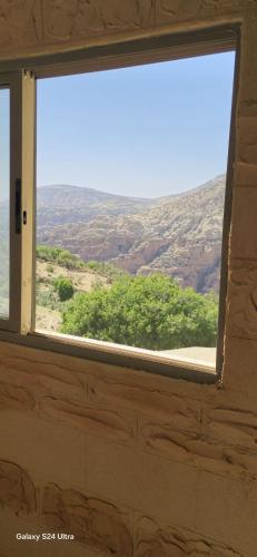 a window in a room with a view of the desert at Dana historic village in Dana