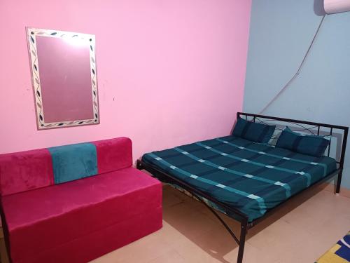a room with a bed and a couch at SIDHU GUEST HOUES -400 walking distance From golden Temple in Amritsar