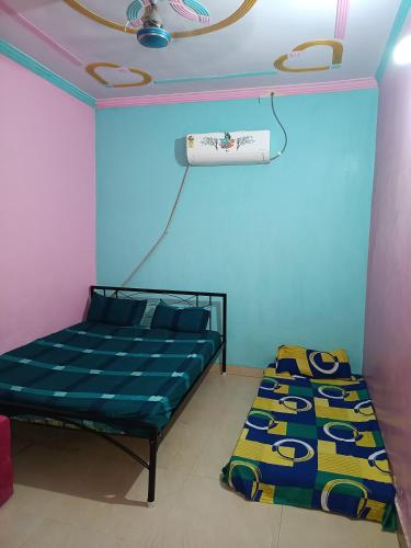 a bedroom with a bed and a blue wall at SIDHU GUEST HOUES -400 walking distance From golden Temple in Amritsar