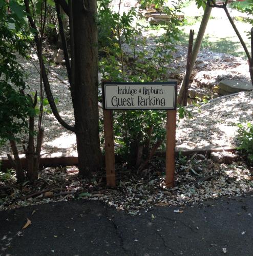 a sign in front of a forest with a tree at Indulge at Hepburn in Hepburn Springs