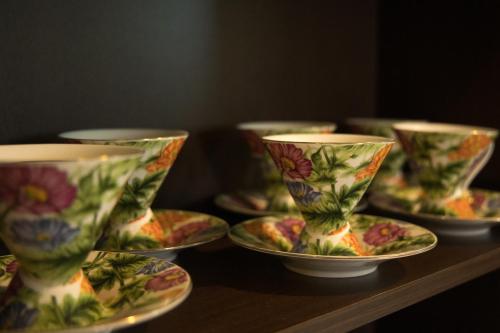 a group of cups and saucers on a table at Villa Kalin in Natsovtsi