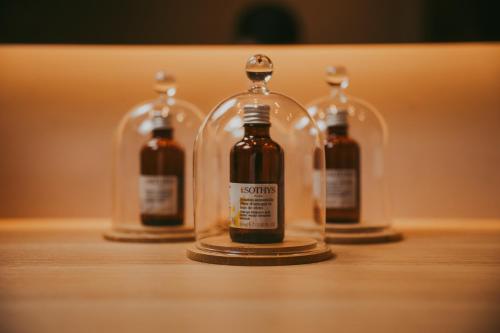 a group of four glass bottles on a table at RELAIS COLLE BUONO in Alvito