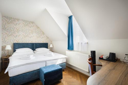 Postel nebo postele na pokoji v ubytování Hotel Tanzberg Mikulov
