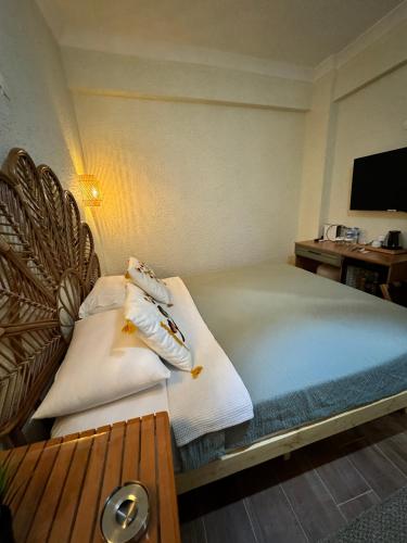 a bedroom with a bed with towels on it at ADOS Otel in Marmara
