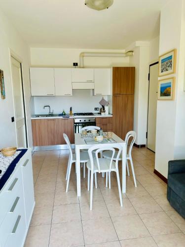 a kitchen and dining room with a table and chairs at Appartamento delle Vele in Bellaria-Igea Marina