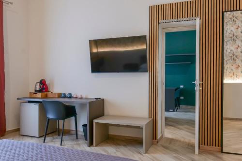 a room with a desk and a table with a chair at Rooftop Parthenopeo Contemporary Rooms in Naples