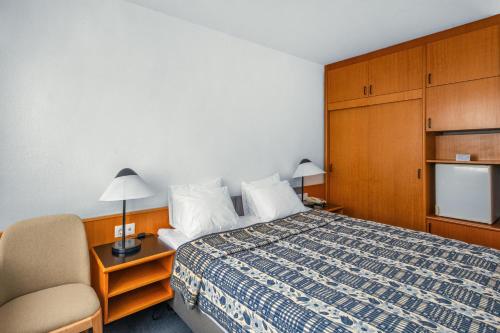 Кровать или кровати в номере Hotel Club Tihany