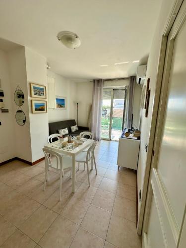a kitchen and a living room with a table and chairs at Appartamento delle Vele in Bellaria-Igea Marina