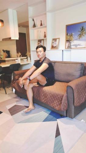 a man sitting on top of a couch at Tower A one bedroom in Lapu Lapu City