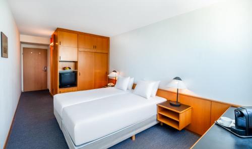 Кровать или кровати в номере Hotel Club Tihany