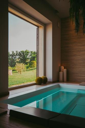a swimming pool in a room with a window at RELAIS COLLE BUONO in Alvito
