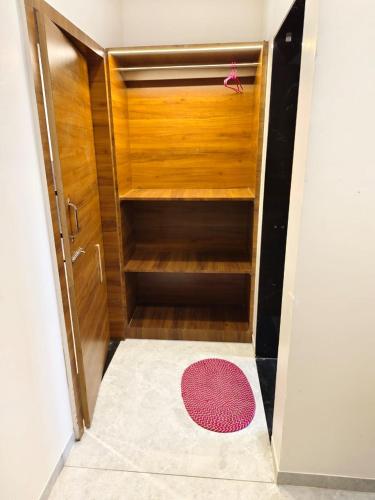 a small closet with a red rug in a room at Hotel Keshar Palace in Sonai