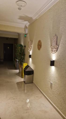 a hallway with a wall with art on it at ADOS Otel in Marmara