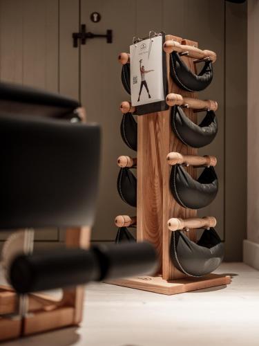 a wooden wine rack with black shoes at Chalet Cecilia inklusive Summercard by MYALPS in Obergurgl