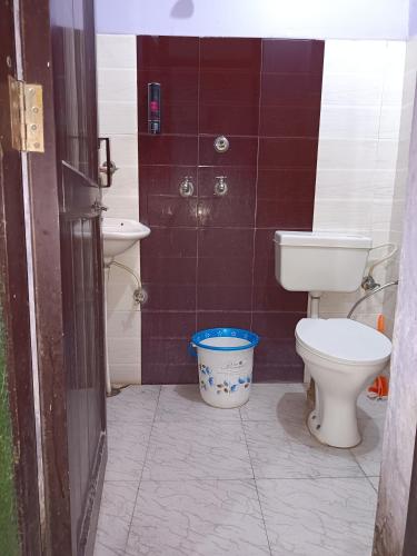 a bathroom with a toilet and a bucket in it at SIDHU GUEST HOUES -400 walking distance From golden Temple in Amritsar