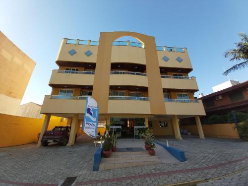a large building with a sign in front of it at Bombinhas Praia Apart Hotel - unidade rua Bem Te Vi in Bombinhas