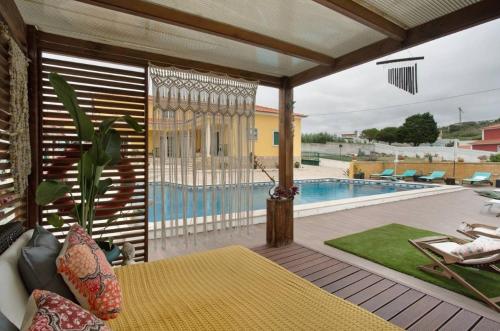 a room with a patio with a swimming pool at Porto Dinheiro Beach II in Casal do Cigano