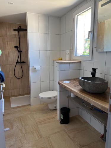 a bathroom with a sink and a toilet at Au point du jour Ch1 in Récourt-le-Creux