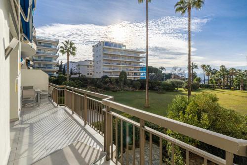 - un balcon dans un bâtiment avec des palmiers dans l'établissement Splendid apartment, Sea view, Parking - Croisette, à Cannes