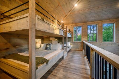a bedroom with two bunk beds in a log cabin at Pet friendly family cabin with firepit creek outdoor kitchen playset & more in Broken Bow