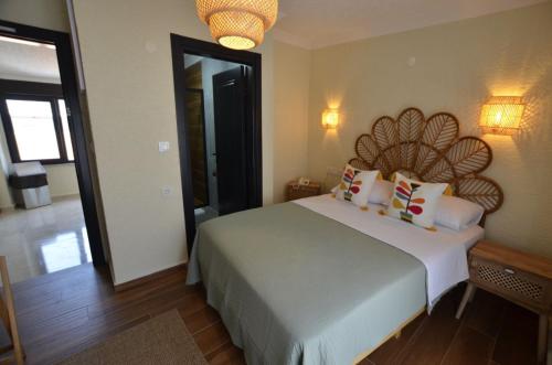 a bedroom with a large white bed with pillows at ADOS Otel in Marmara