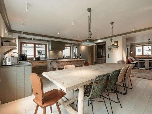 a kitchen and dining room with a wooden table and chairs at Chalet Cecilia inklusive Summercard by MYALPS in Obergurgl