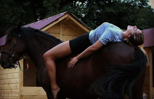 a woman laying on the back of a horse at The Countryside Retreat in Rankovce