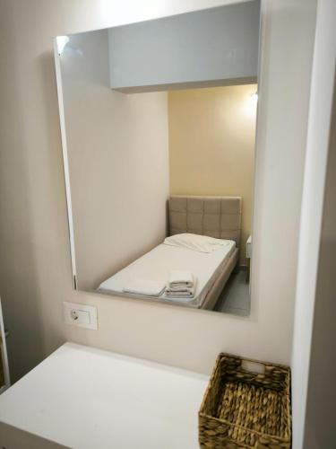 a small room with a bed and a mirror at Aggelika Apartments in Lithakia