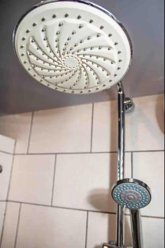 a shower head is hanging from a ceiling at Beach Life Apartments in Jan Thiel