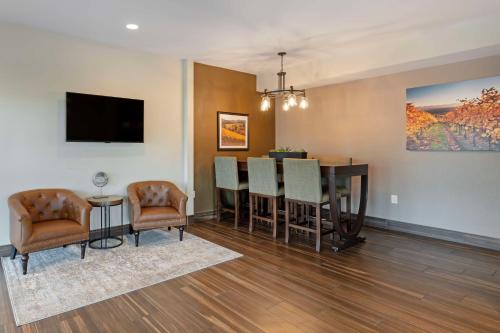 a living room with a table and a dining room at Best Western Plus Inn at the Vines in Napa