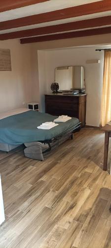 a bedroom with a bed and a wooden floor at Villa Vinci in Recanati