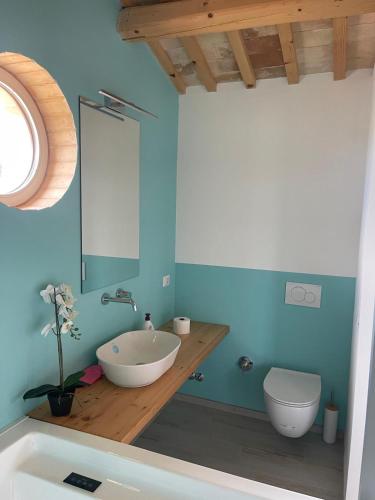 a bathroom with a sink and a toilet at Villa Vinci in Recanati