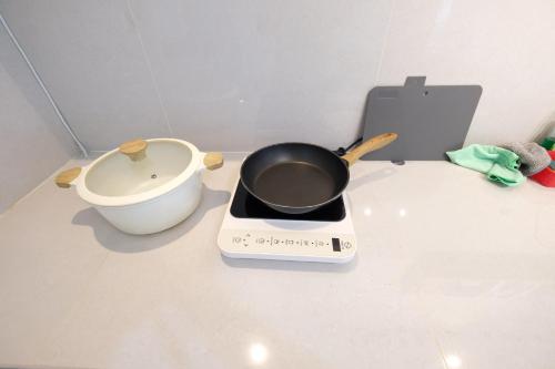 a pot on a stove next to a toilet at Delipark Mall 3 Bedrooms 3 Bathrooms 8-10 Pax Empire Premium Tower Level 28 in Medan