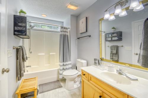 a bathroom with a sink and a toilet and a mirror at SUMMER Vacation Getaway Pets Welcome Remodeled in Myrtle Beach