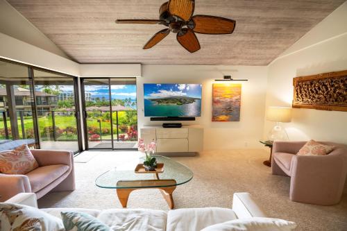 a living room with a couch and a ceiling fan at Elua 406 in Wailea