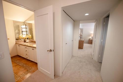a white bathroom with a sink and a mirror at Elua 406 in Wailea