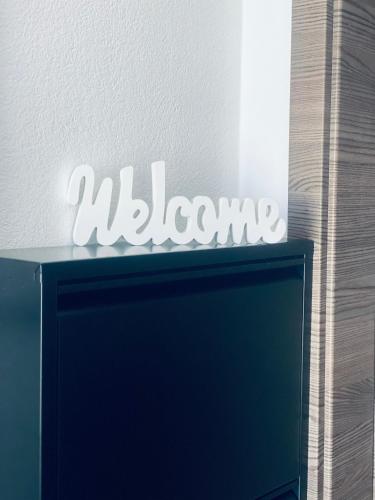 a welcome sign on top of a computer monitor at Apartment Center Zilina near Train and Bus station in Žilina