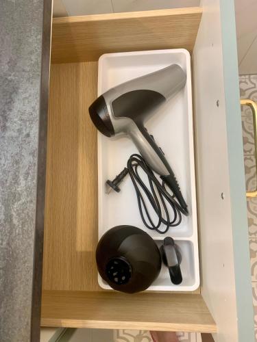 a white drawer with a hair dryer in it at Apartament Teatralny - Komfort w Sercu Miasta Klimatyzacja in Opole