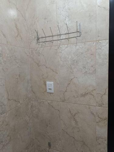 a bathroom with a marble shower with a wall at loft 01 Manaus in Manaus