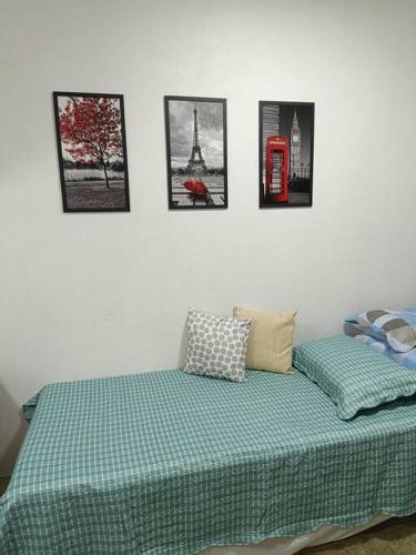 a bedroom with a bed and pictures on the wall at loft 01 Manaus in Manaus