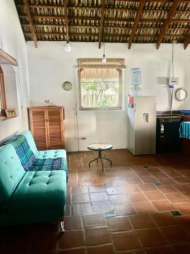 a living room with a couch and a refrigerator at Lakefront bungalow - Relaxation Plus in Santa Cruz La Laguna