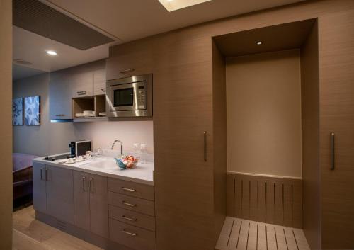 a bathroom with a sink and a microwave at Four Points by Sheraton Izmir in Izmir