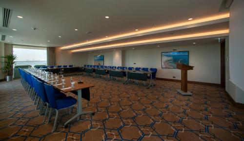 a conference room with tables and chairs and a podium at Four Points by Sheraton Izmir in Izmir